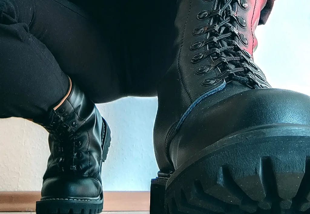 Honey of Babylon in her signature combat pose — powerful, authentic, and deeply rooted in impact play BDSM.