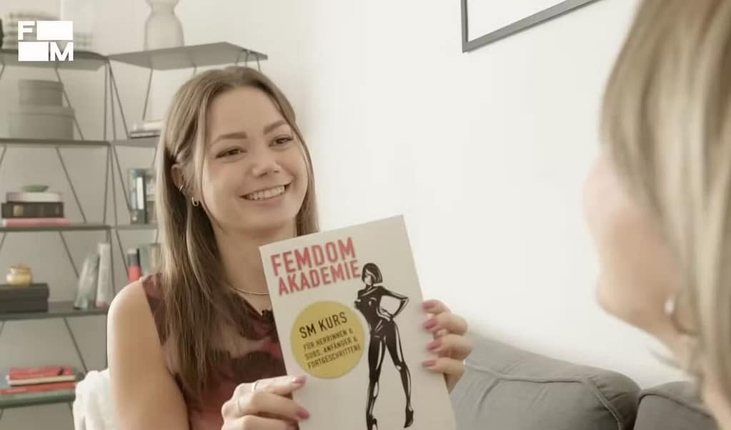 Domina Franzi with the book Femdom Academy by Lady Sas