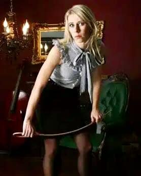 Mistress Danica, a Dominatrix working in Germany and the UK, posing with a riding crop