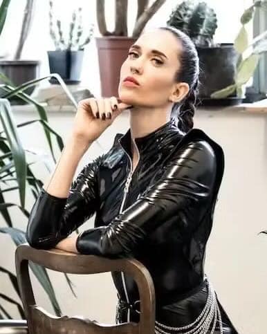 Mistress Yuna, a Stuttgart-based Dominatrix, wearing a glossy black latex outfit