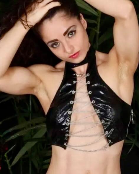 Miss Meelina, Rome-based Dominatrix, wearing a black leather top.