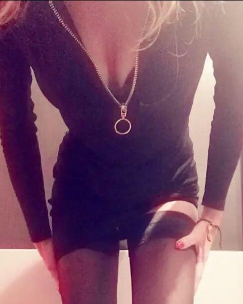 Lady Silvi, private Femdom, wearing a black outfit and stockings.