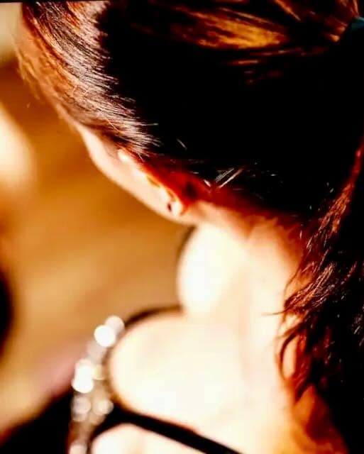 Close-up of Sreni, a private Femdom in a cuckold relationship, photographed from behind.