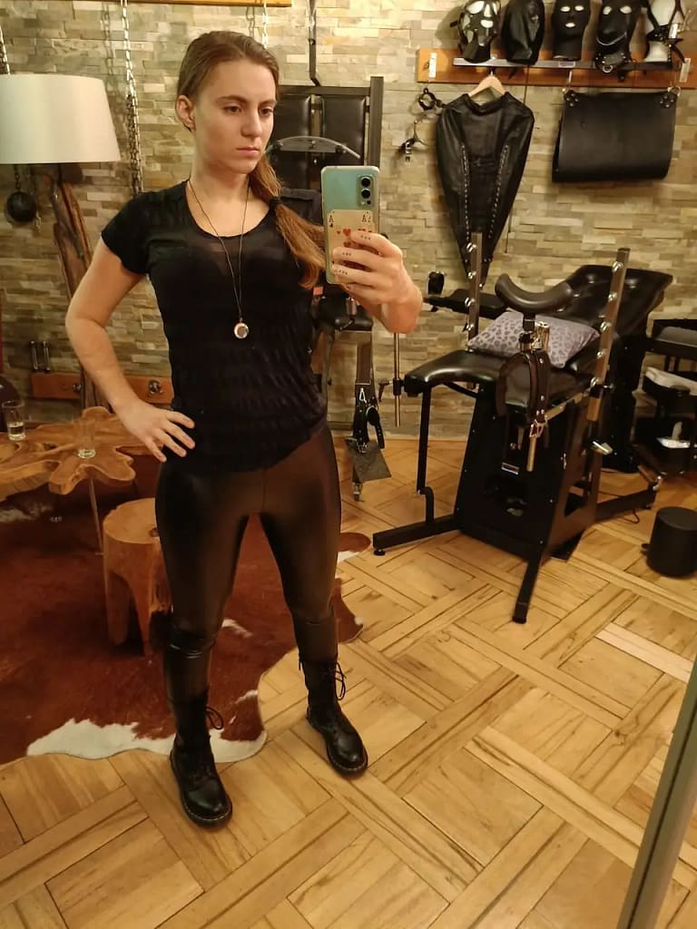 Miss Juli from Zurich, Switzerland, taking a mirror selfie in her BDSM studio.