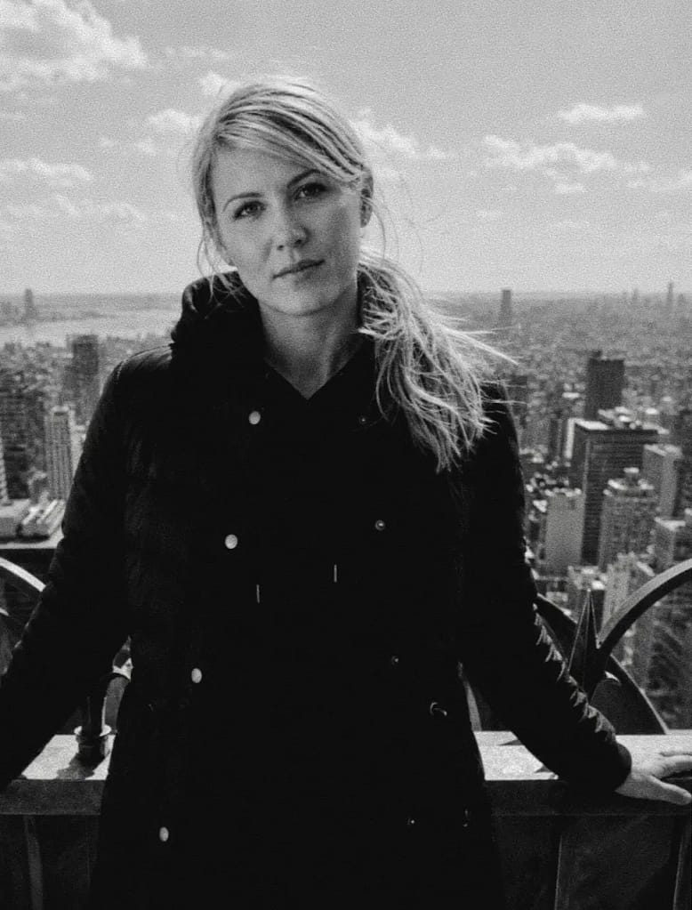 Submissive BDSM escort jO posing above the New York City skyline.