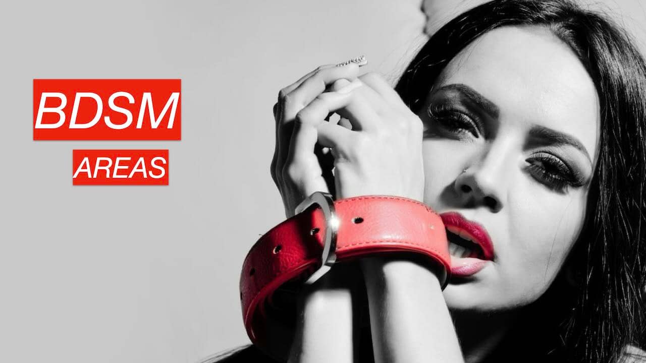 BDSM areas: woman in restraint, wrists tied with a leather belt.